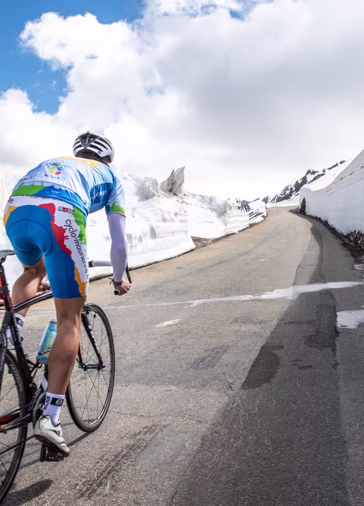Cycling in the snow on the Route des Grandes Alpes