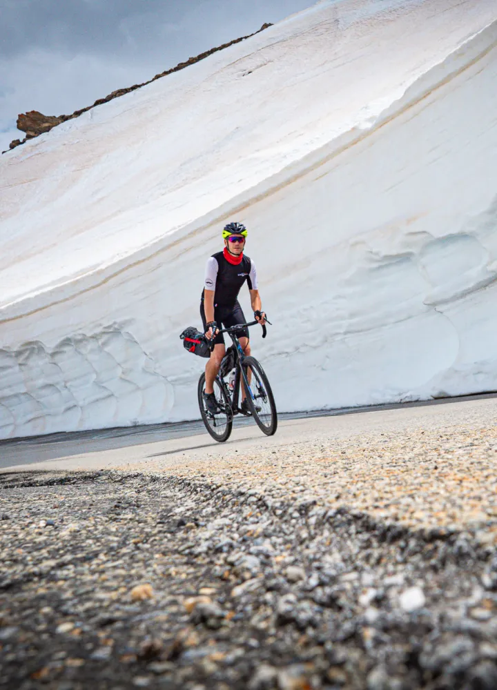 Cyclists snow walls galibier