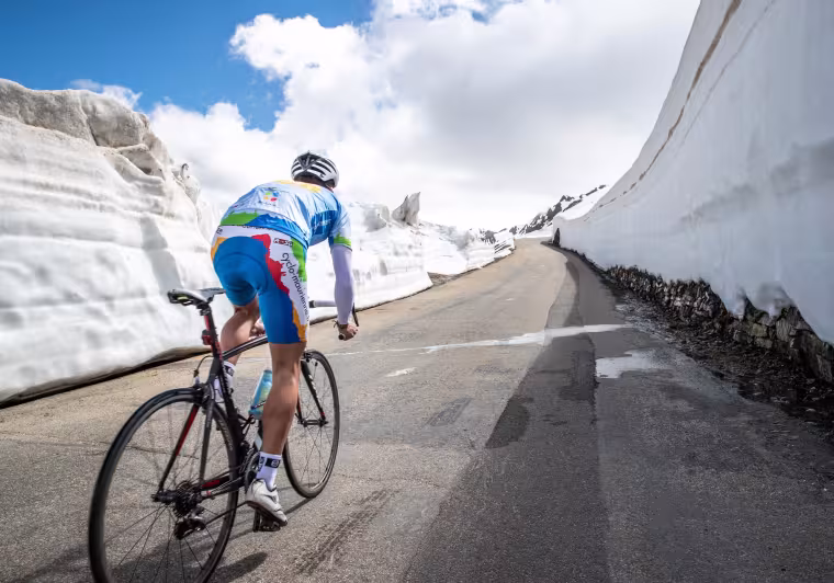 Cycling in the snow on the Route des Grandes Alpes